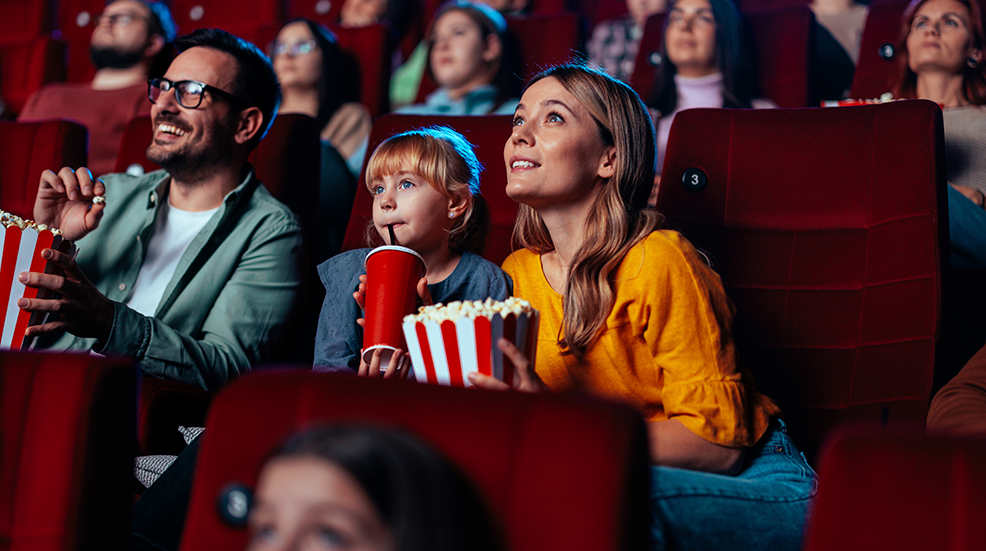 Family enjoying movie in theater